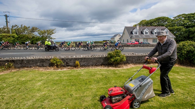 Thady Kilgannon mows his lawn in Dromore West, Co Sligo as the field passes by