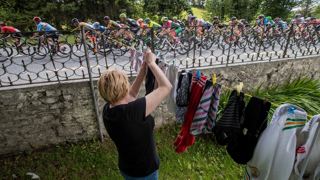 Meenagh Gillespie from Killyverry hangs out her washing as the riders pass by