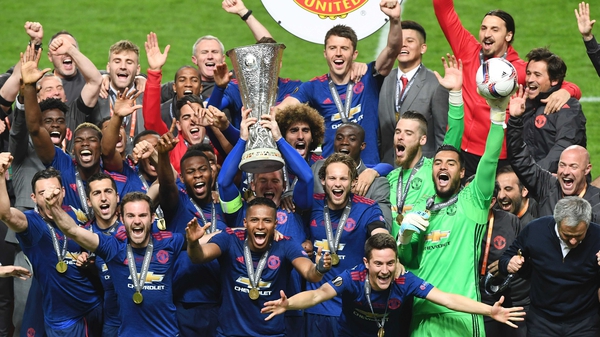 Wayne Rooney hoists the Europa League trophy
