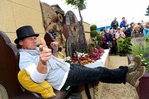 Des Kingston in his Super Garden as admirers of his creation look on