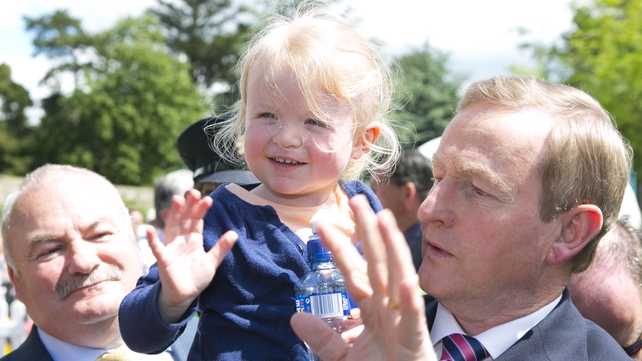 Taoiseach Enda Kenny and little pal wave to crowds at Bloom