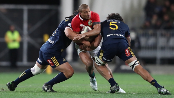 Jonathan Joseph of the Lions is tackled by Aki Seiuli (L) and Jack Hemopo (R)