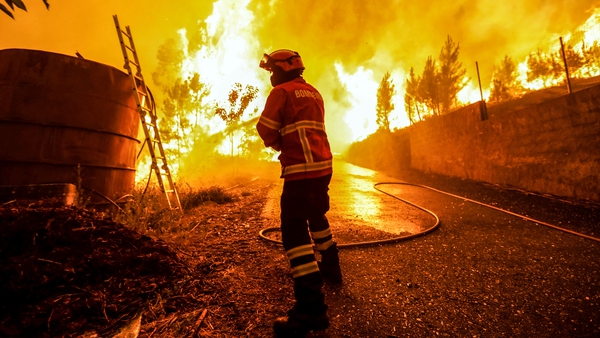 A firefighter battles with a fire in Pampilhosa da Serra, central Portugal