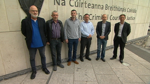 Six men are accused of falsely imprisoning Joan Burton and her adviser Karen O'Connell
