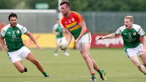 Carlow's Eoin Ruth escapes the attentions of two London players