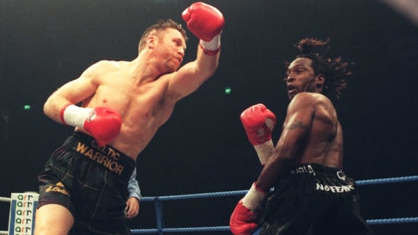 Steve Collins (L) swings and misses Nigel Benn in their November 1996 rematch in Manchester