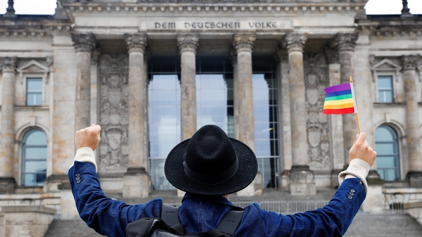 A man celebrates the vote outside the German parliament