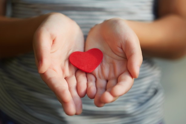 girl holding a red heart