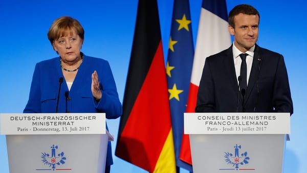Angela Merkel (L) and Emmanuel Macron have expressed differing sentiments on EU reform