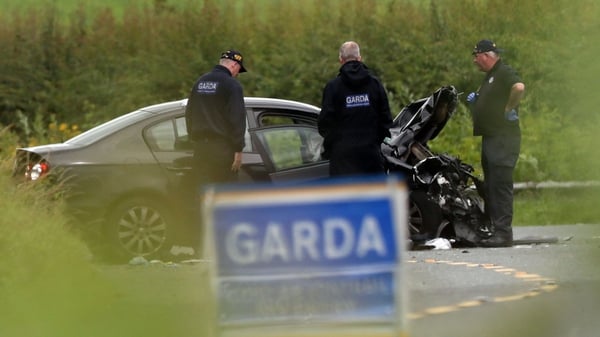 Gardaí examine a car following a crash in Co Louth in which three women died