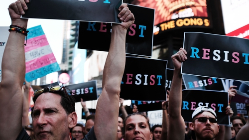 Dozens of protesters in Times Square show their anger at reinstatement of transgender recruitment ban in military