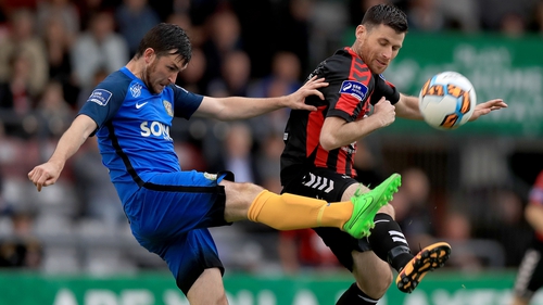Dinny Corcoran and Ryan Brennan challenge for the ball