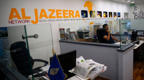 Employees of Qatar-based news network and TV channel Al-Jazeera are seen at their Jerusalem office in July
