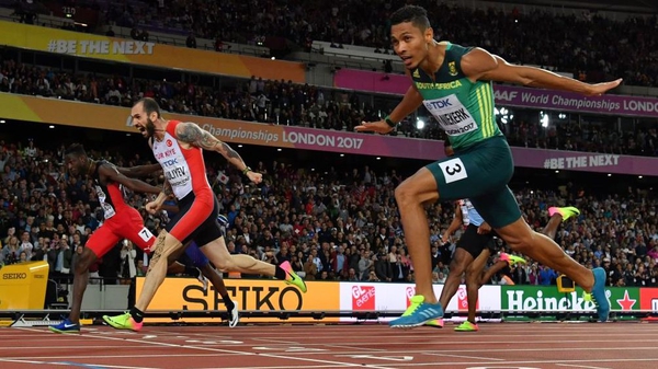 Turkey's Ramil Guliyev (C) crosses the finish-line ahead of South Africa's Wayde Van Niekerk (R) and Trinidad and Tobago's Jereem Richards (L) in the final of the men's 200m