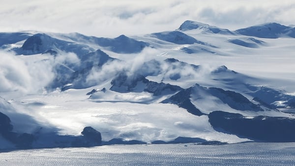 Mountains stand near the coast of West Antarctica