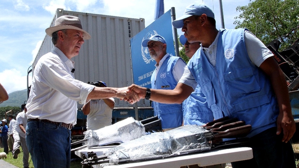 President Santos (L) was on hand to witness the last of the FARC's weapons delivered to the UN Mission in Colombia