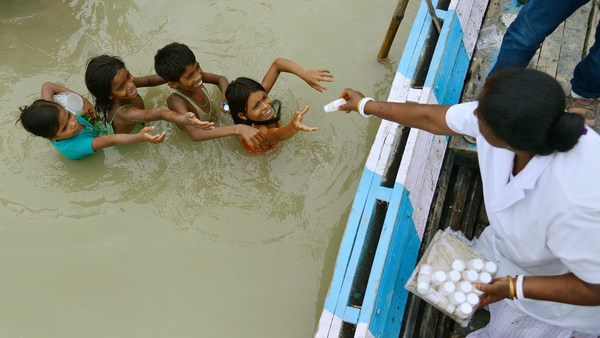 Children collect medicine at a medical camp in the flood affected Morigaon district of Assam State, India