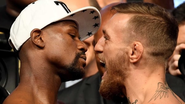 Floyd Mayweather (L) and Conor McGregor at the weigh-in