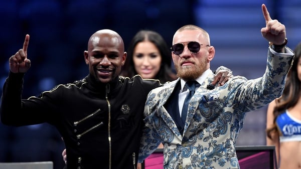 Floyd Mayweather (L) with Conor McGregor after their fight