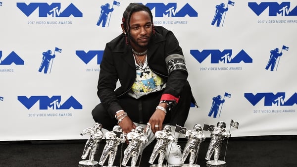 Kendrick Lamar shows off his awards haul backstage