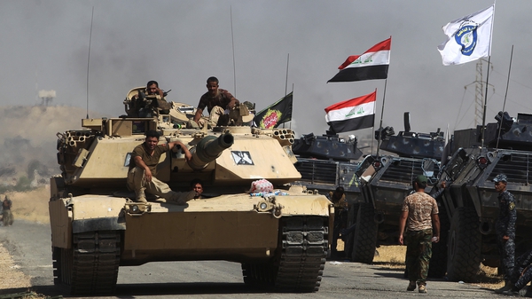 Iraqi forces take position on a road as they advance towards Al-Ayadieh village, the last remaining active front line near Tal Afar