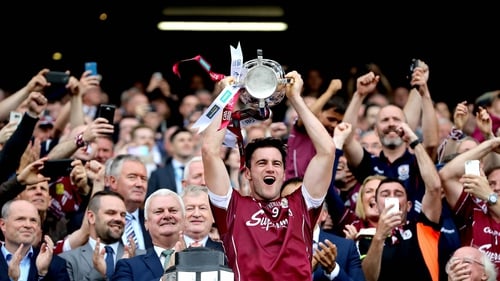 Galway captain David Burke hoists the silverware in the Hogan Stand in 2017