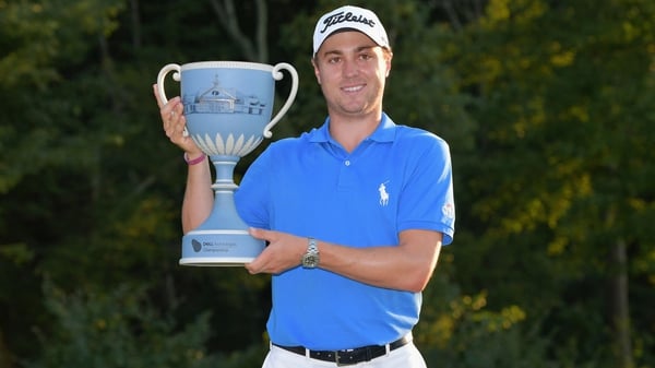 Justin Thomas poses with his trophy