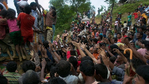 Food is handed out to Rohingya refugees at a camp in Bangladesh