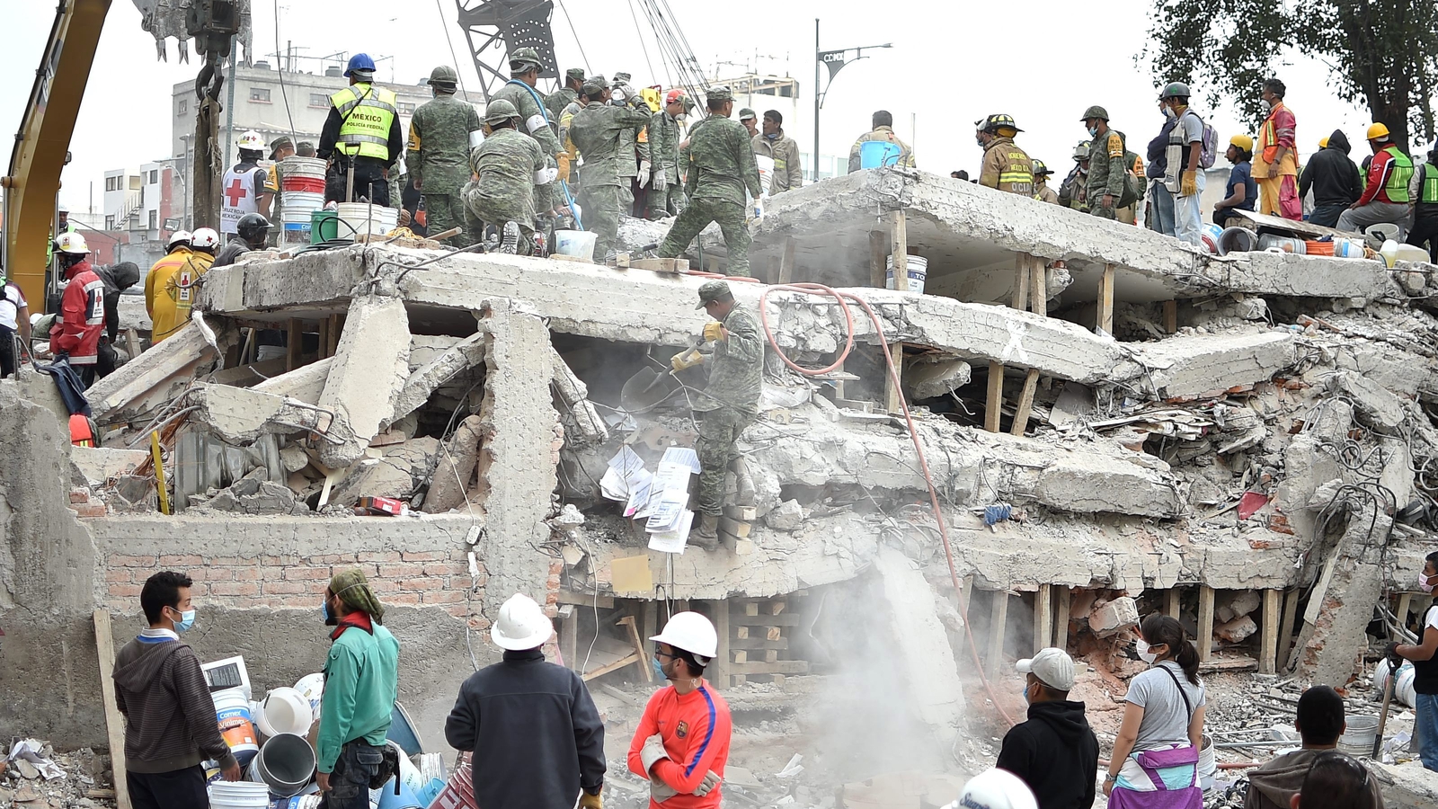 Bystanders Gather Around Collapsed Shopping Mall in Mexico City