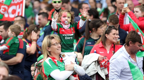 A young Mayo supporter cheers on her team