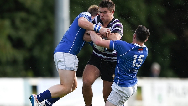 Terenure's Ted Fitzgerald is tackled by Patrick Lavelle and Tim Maupin