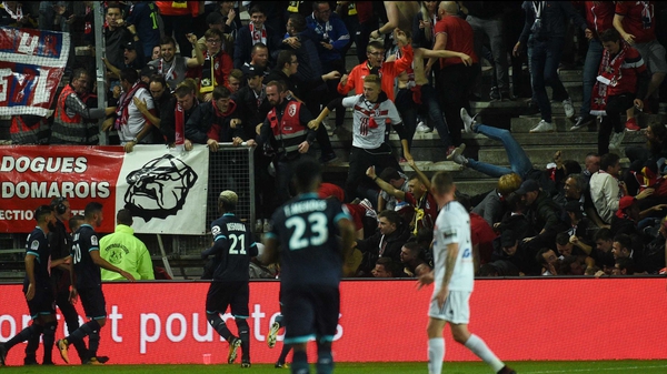 Chaotic scenes as Lille supporters fall through a barrier following Fode Ballo-Toure's goal
