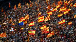 People with Spanish and Catalan flags gather during the rally in Barcelona