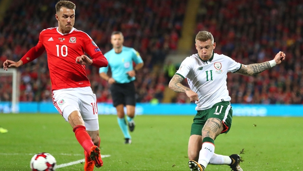 James McClean gets a shot off despite the attentions of Aaron Ramsey