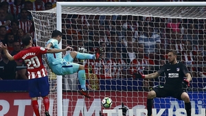 Luis Suarez scoring the equaliser that denies Atletico Madrid a victory.