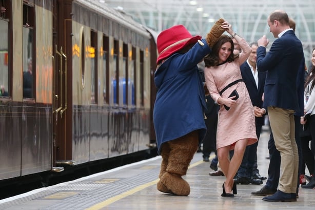 Catherine, Duchess of Cambridge dances with Paddington bear on platform 1 at Paddington Station