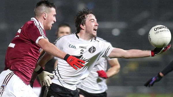 Omagh's Gregory Murray (R) and Slaughtneil's Meehaul McGrath battle for possession