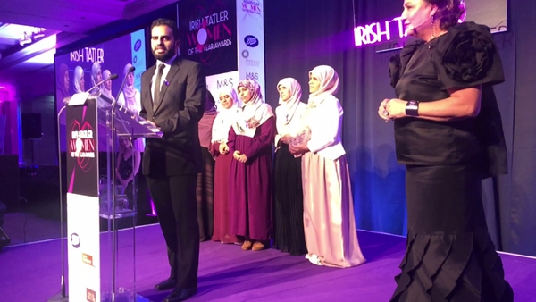 Ibrahim Halawa on stage with Norah Casey (right) and his five sisters