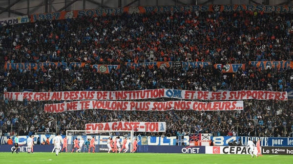 The banners read: 'You thought you were above the institution OM and its supporters. We don't want you in our colours anymore. Evra get lost!'