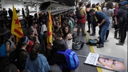 Protesters hold a picture of deposed Catalan regional government's foreign relations chief Raul Romeva reading 'Freedom' as they block train tracks at the Sants Station in Barcelona