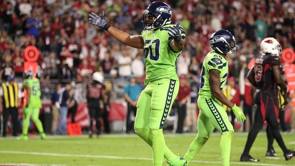 Outside linebacker K.J. Wright of the Seattle Seahawks celebrate a turnover against the Cardinals