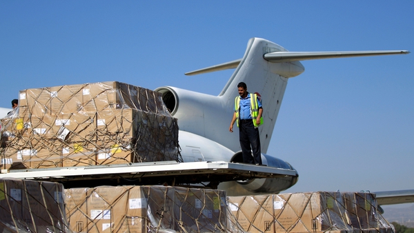 A cargo of vaccines is unloaded from a plane after it landed in Sanaa