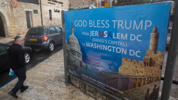 A Jewish man walks past a poster blessing Donald Trump in Jerusalem, Israel