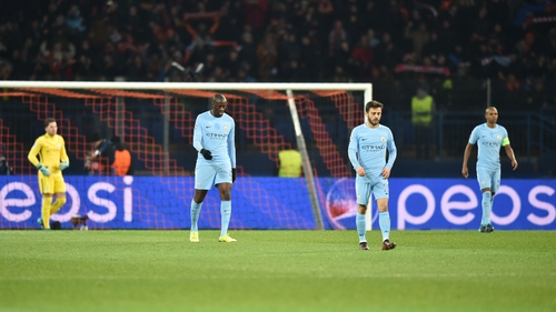 Manchester city's players walk on the pitch after conceding the first goal to Shakhtar