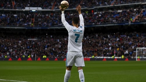 Ronaldo shows off his fifth Ballon d'Or trophy to fans within the Bernabeu prior to start the match between Real Madrid and Sevilla