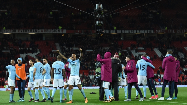 Manchester City players celebrate victory at Old Trafford