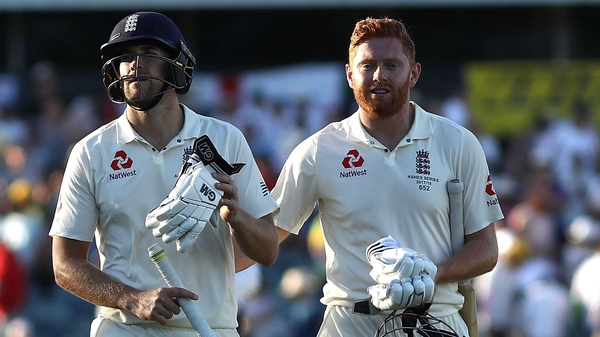 Dawid Malan (L) and Jonny Bairstow of England leave the ground at stumps on 110 not out