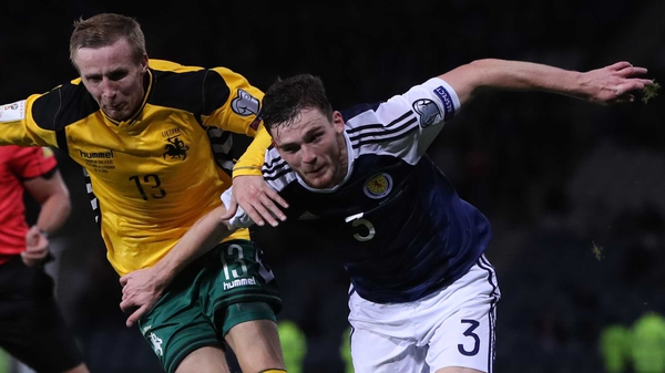 Karolis Chvedukas (L) in action against Scotland's Andy Robertson during the 2018 World Cup qualification campaign
