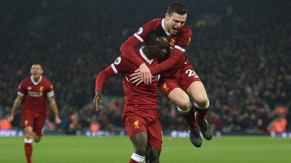 Sadio Mane is mobbed by Andy Robertson after his goal