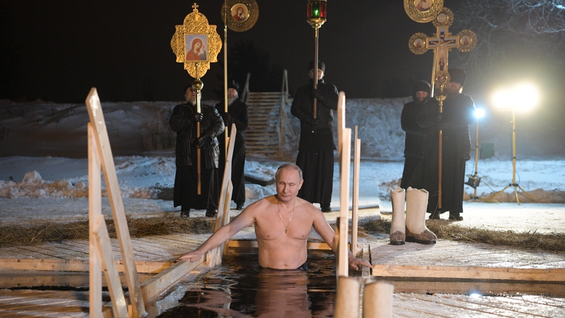 Vladimir Putin lowers himself into the freezing waters of Lake Seliger
